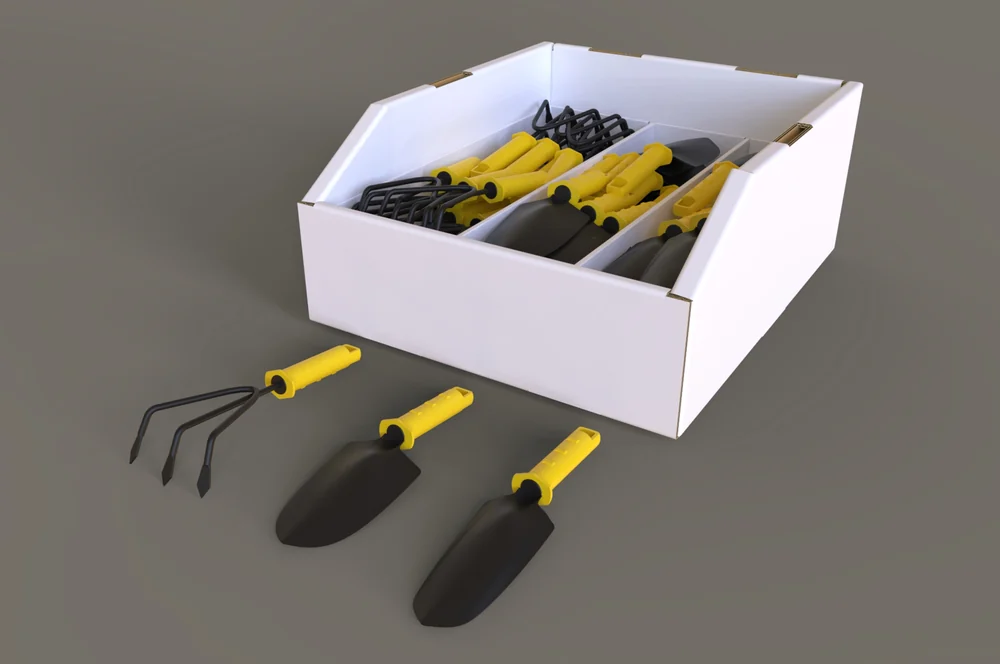 3D render of a white corrugated bin display with dividers, holding yellow-handled garden tools, with three tools laid out beside it