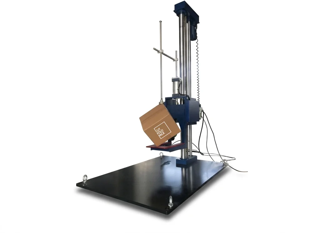 Drop test machine holding a Cut Fold Pack corrugated box at an angle, ready for a drop test