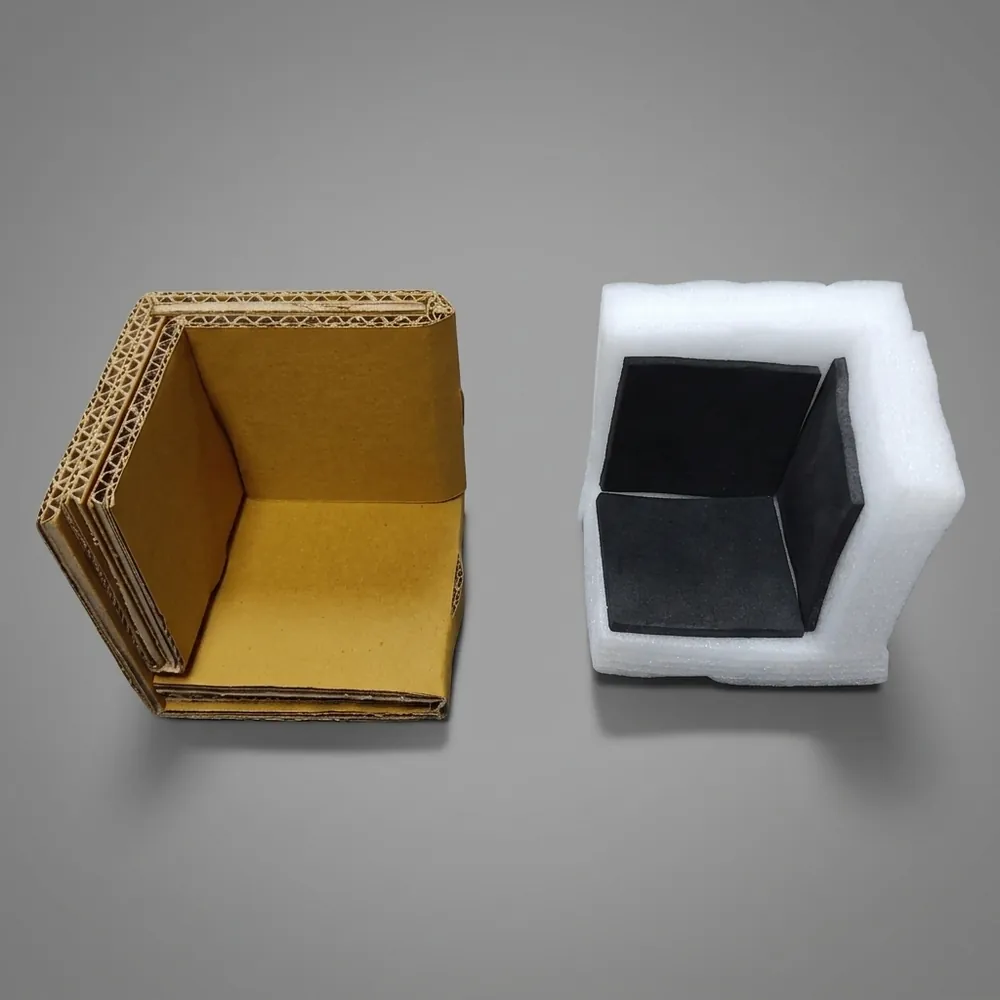 Multi-layer corrugated cardboard corner protector shown next to a white foam corner protector with a black foam liner