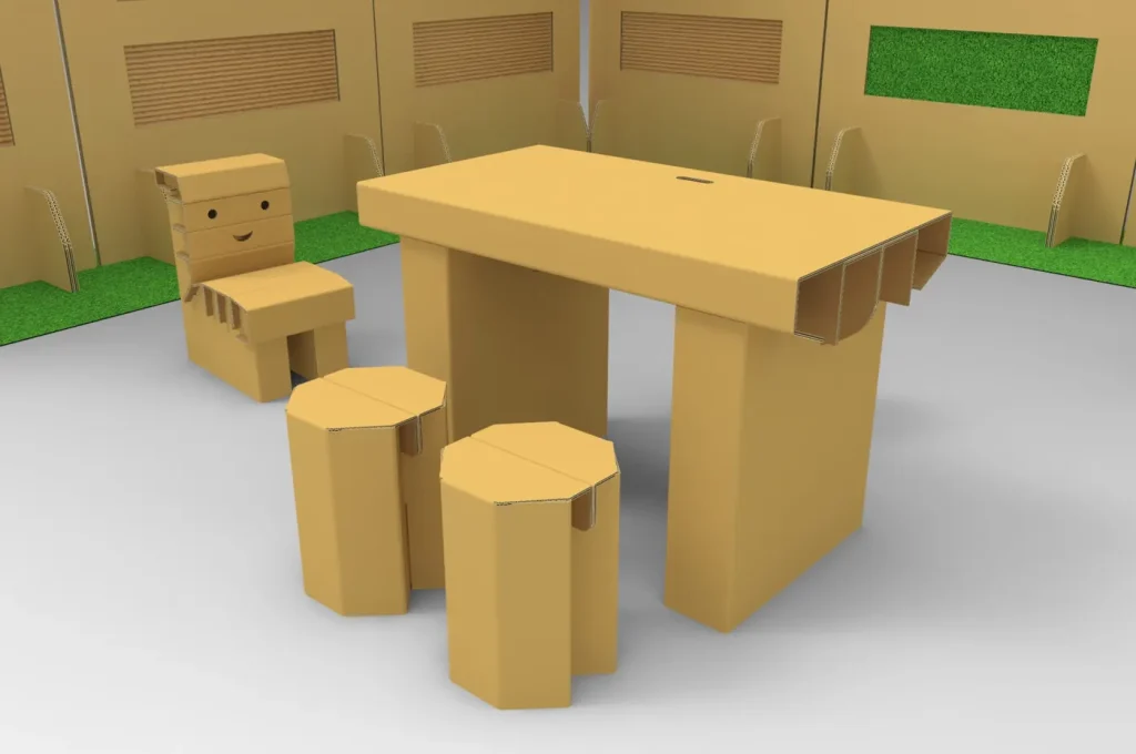 3D render of a cardboard desk, a chair with a smiling face and two octagonal stools inside a cardboard exhibition space with green panels
