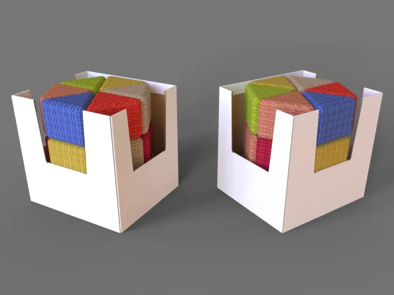 Two white corrugated dump bin displays with U-shaped cut-outs holding colourful fabric cubes