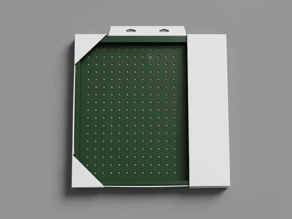 White board sleeve and corner-lock packaging with a hang tab for a green pegboard panel