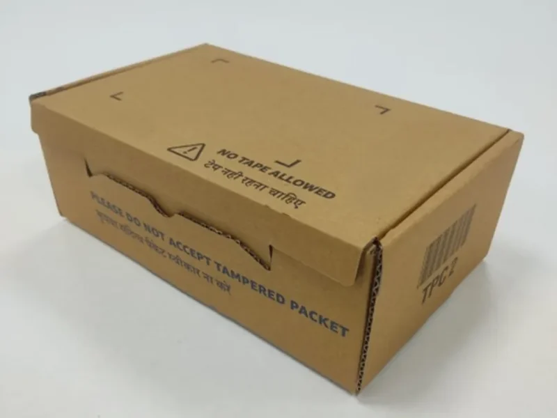 Kraft corrugated e-commerce box with a tear-open closure and printed English and Hindi warnings that read no tape allowed and do not accept tampered packet