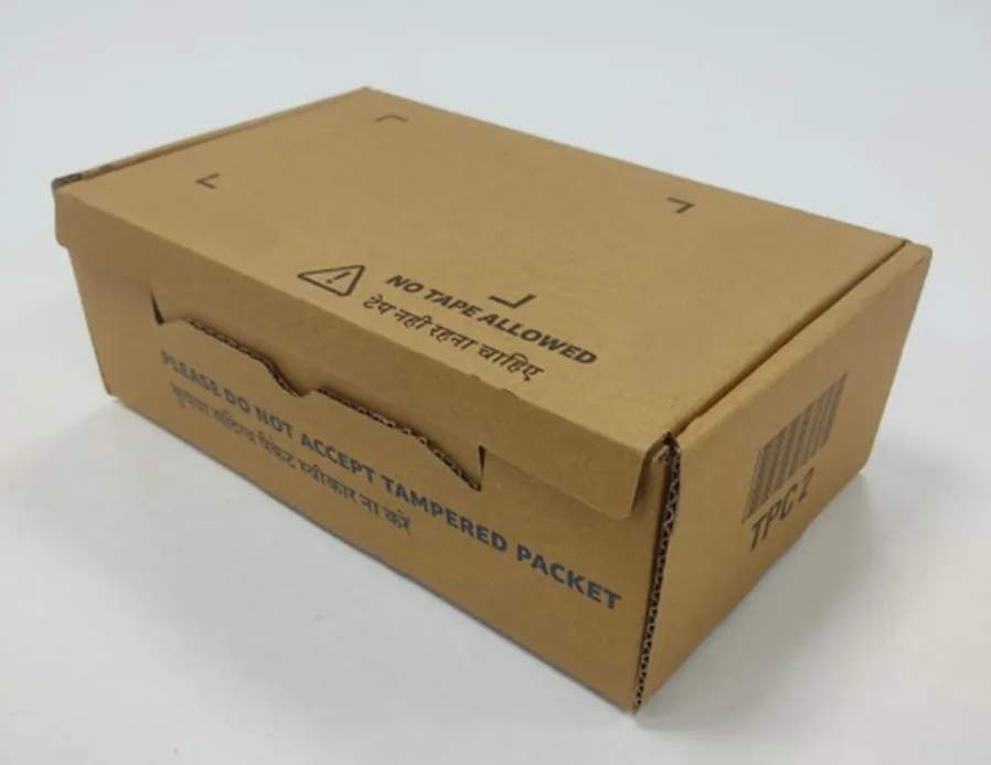 Kraft corrugated e-commerce box with a tear-open closure and printed English and Hindi warnings that read no tape allowed and do not accept tampered packet